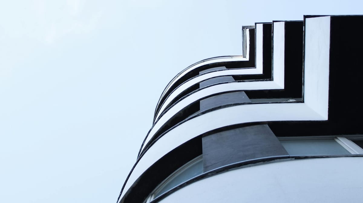 Dynamic low angle view of a modern building facade in Katowice, highlighting sleek architectural lines.
