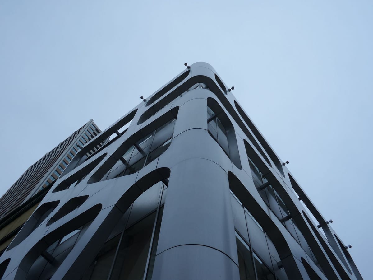 Low angle view of a modern skyscraper with a sleek, contemporary facade.