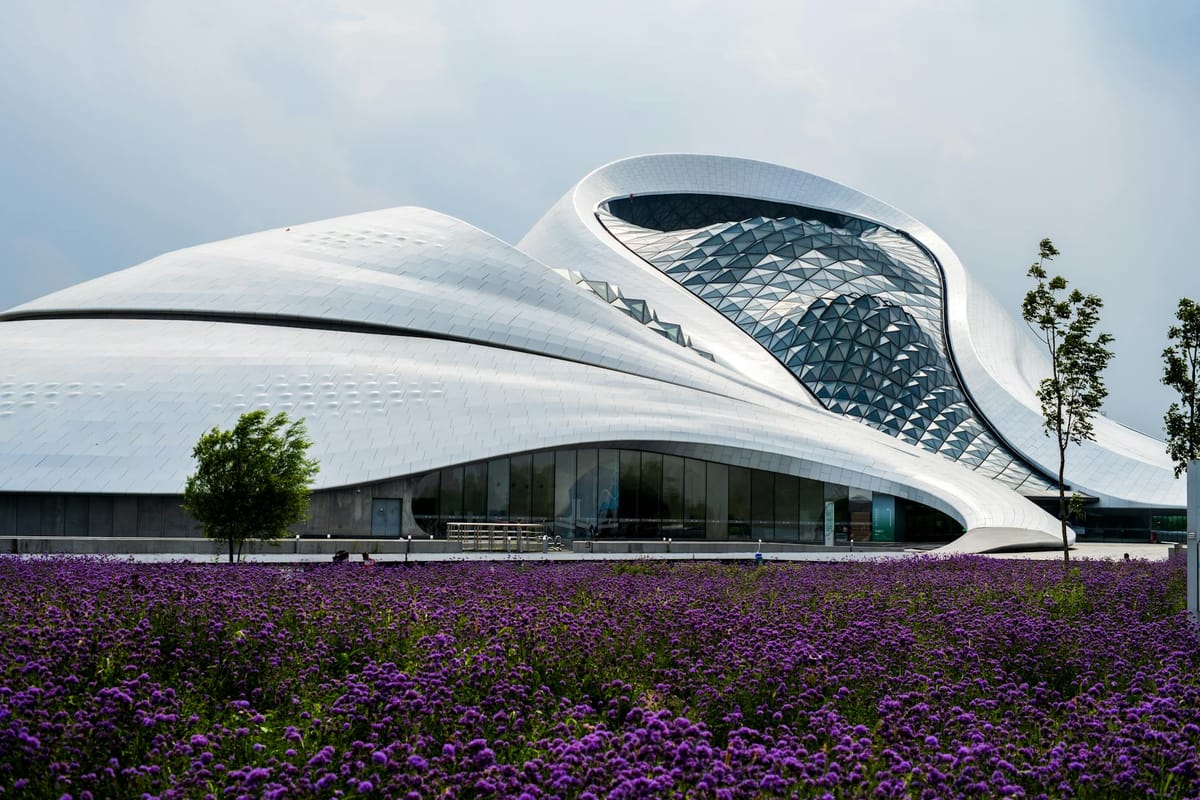 Modern architecture with a field of flowers in the foreground.