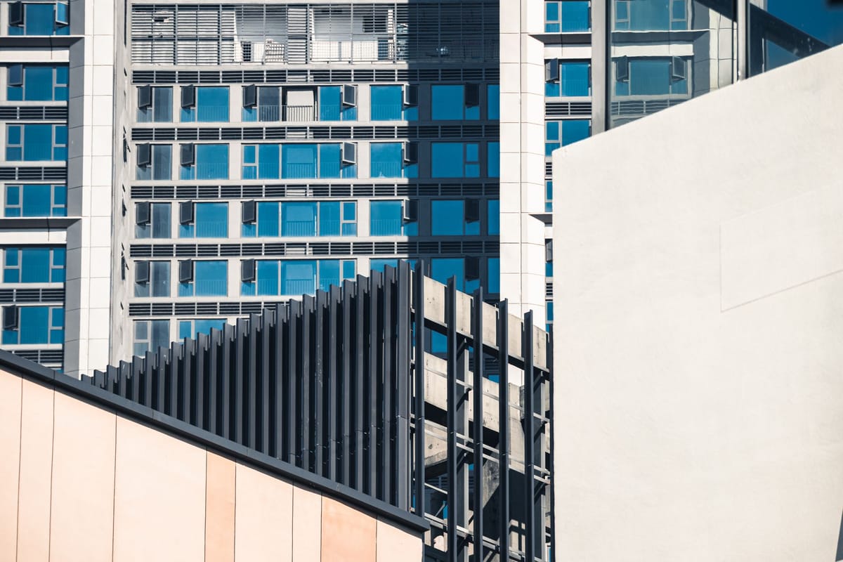 Abstract view of modern architecture with geometric shapes and glass facade.