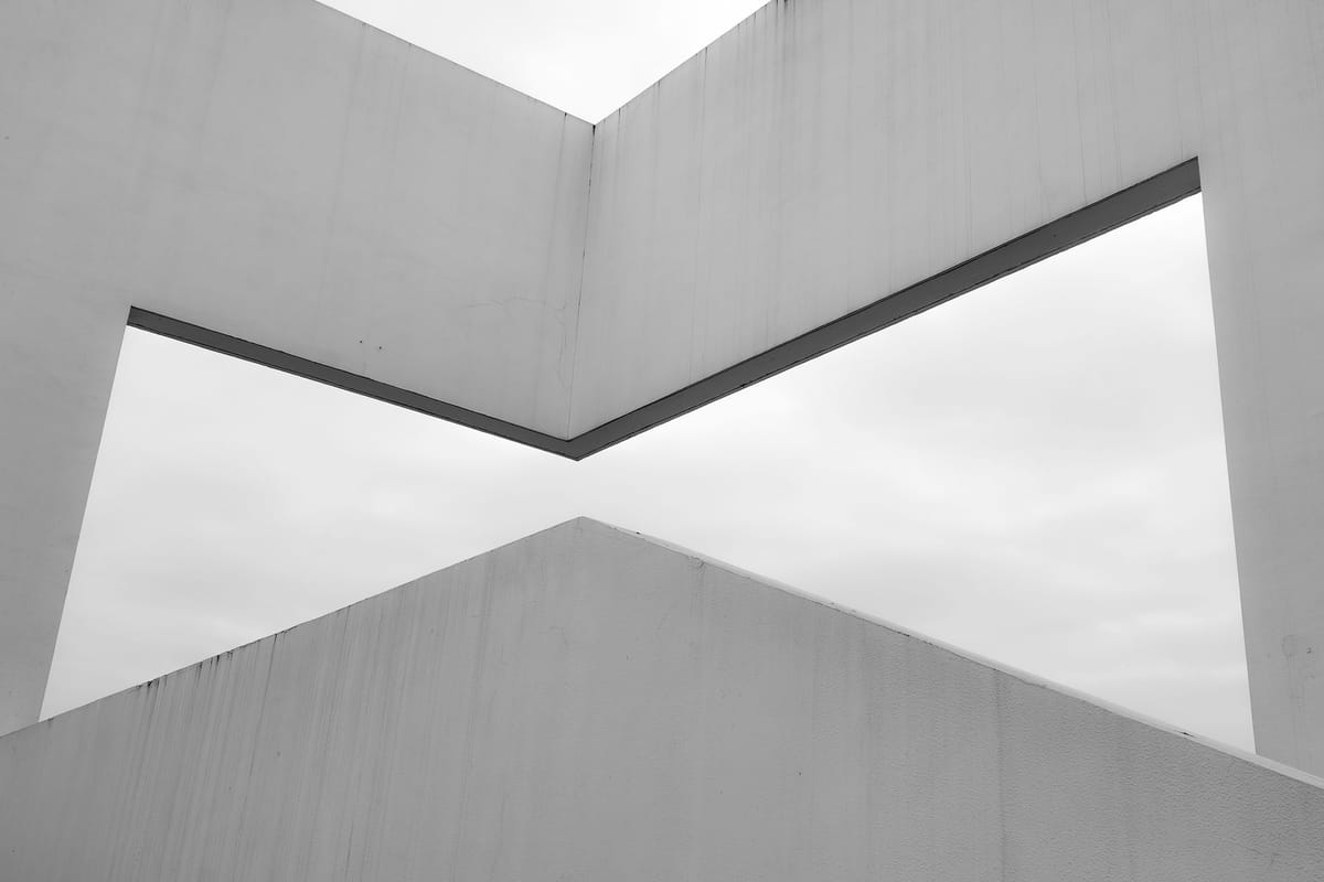Monochrome architectural image showcasing minimalist and abstract geometric shapes.
